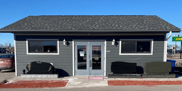 A building with two doors and a black roof