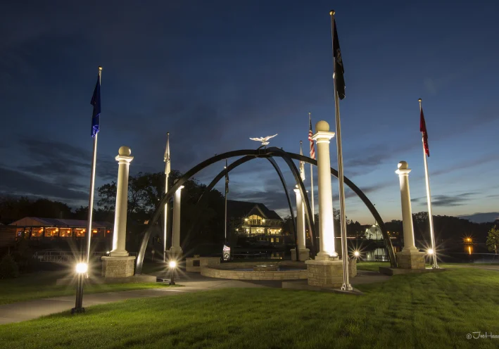 A park with flags and arches in the middle of it